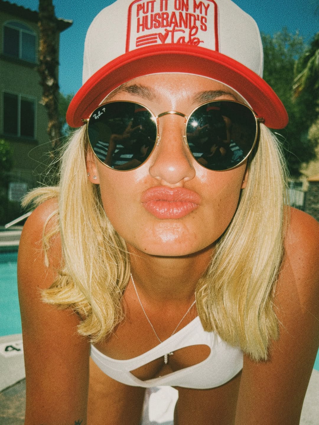 Guest poolside in a custom trucker hat